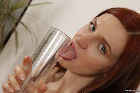 First-Class ukrainian red-head Lina Arian sticks a dildo in her pussy after disrobing